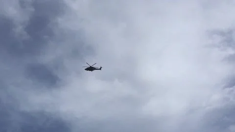 A helicopter hovers over the sky Stock Footage 144857005