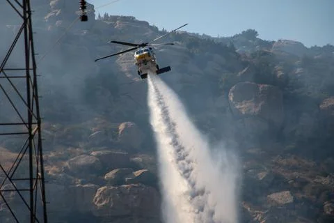A helicopter from the LACFD performs a water drop and observation during a br Stock Photos
