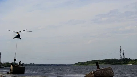 Helicopter with a ladle over the river Video stock 77716713