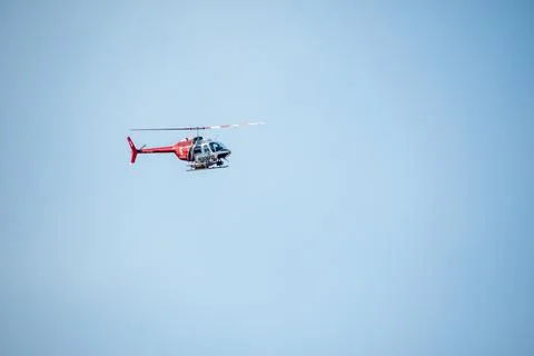 A helicopter from the LAFD performs a water drop and observation during a bru Stock Photos