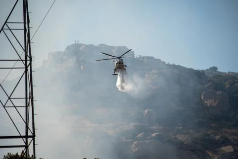 A helicopter from the LAFD performs a water drop and observation during a bru Stock Photos