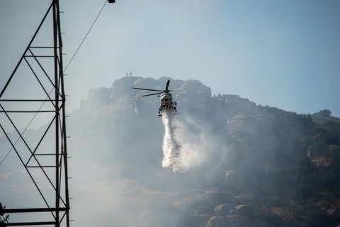A helicopter from the LAFD performs a water drop and observation during a bru 写真素材