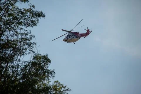 A helicopter from the LAFD performs a water drop and observation during a bru Stock Photos