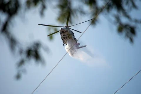 A helicopter from the LAFD performs a water drop and observation during a bru 写真素材