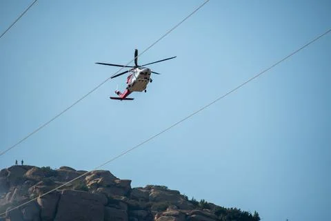 A helicopter from the LAFD performs a water drop and observation during a bru Stock Photos