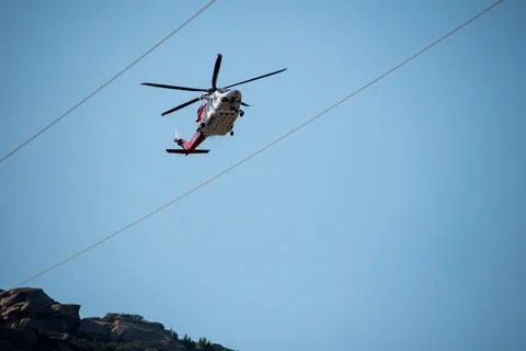 A helicopter from the LAFD performs a water drop and observation during a bru Stock Photos