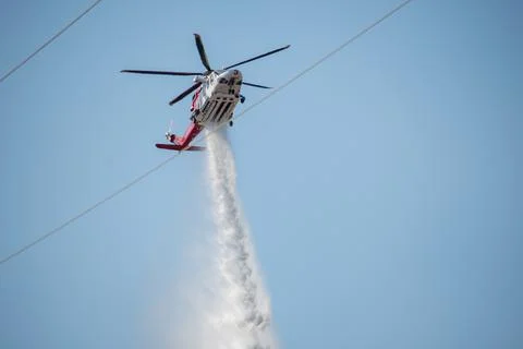 A helicopter from the LAFD performs a water drop and observation during a bru 写真素材