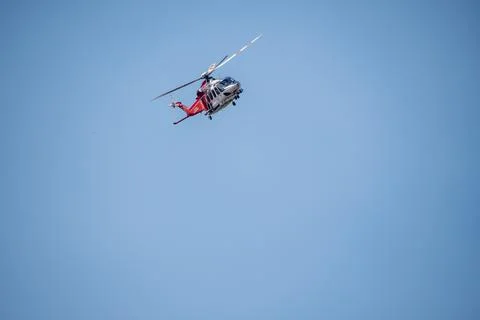 A helicopter from the LAFD performs a water drop and observation during a bru Stock Photos