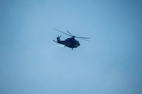 A helicopter from the LAFD performs a water drop and observation during a bru Foto stock
