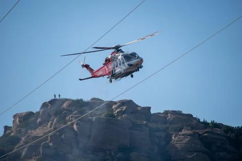 A helicopter from the LAFD performs a water drop and observation during a bru 写真素材