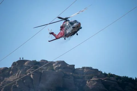 A helicopter from the LAFD performs a water drop and observation during a bru Foto stock