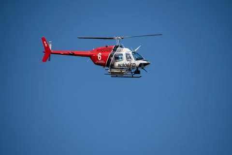 A helicopter from the LAFD performs a water drop and observation during a bru 写真素材