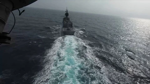 Helicopter land on a ship navigating in the ocean Stock Footage 113297805
