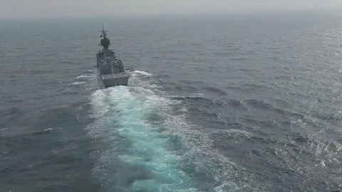 Helicopter landing onto a ship navigating in the ocean Stock Footage 113296210
