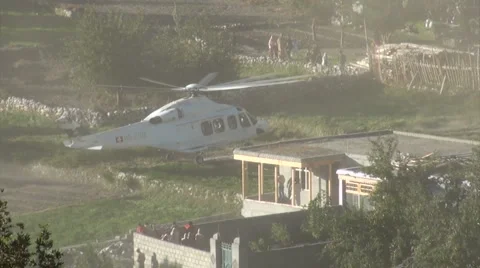 Helicopter lands near Pakistan refugee camp Stock Footage