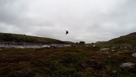 Helicopter lands in the tundra Stock Footage 84380348