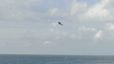 Helicopter looping in slow motion in the blue sky at the beach. 4K. 스톡 동영상 107816559