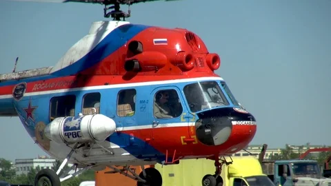 Helicopter MI-2 painted in colors of Russian flag lands in parking lot. Stock Footage 106169045
