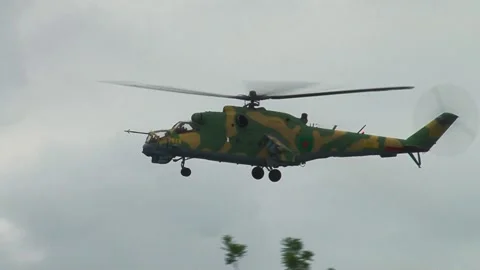 Helicopter Mi-24 / Mi-35 (NATO: Hind) performs U-turn for approaching target. Stock Footage 130238541