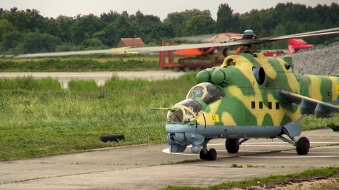 Helicopter Mi-24 or Mi-35 (NATO: Hind) has landed in white circle on platform. Stock Footage 123762477