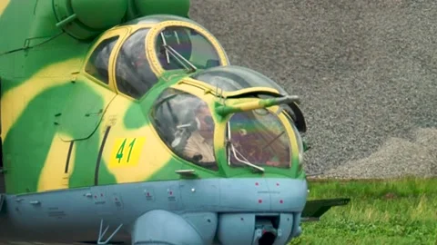 Helicopter Mi-24/Mi-35 (Hind) on helipad with rotating blades before takeoff. Stock Footage 130645816