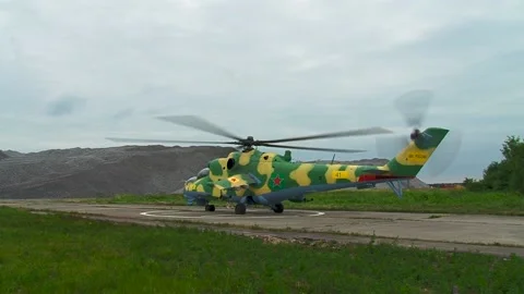 Helicopter Mi-24/Mi-35 (Hind) on helipad with rotating blades before takeoff. Stock Footage 130645982