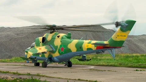 Helicopter Mi-24/Mi-35 (Hind) on helipad with rotating blades before takeoff. Stock-Footage 130646010