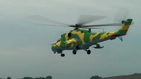 Helicopter Mi-24/Mi-35 (Hind) is landing. Helicopter rotates around its axis. Stock Footage 130646040