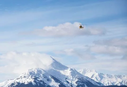 Helicopter over mountains Stock Photos