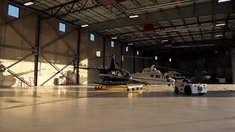 Helicopter parked at a hanger with sun setting and blue sky. Stock Footage 135797584