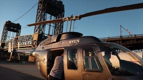 Helicopter parked at a hanger with sun setting and blue sky. Stock Footage 135797607