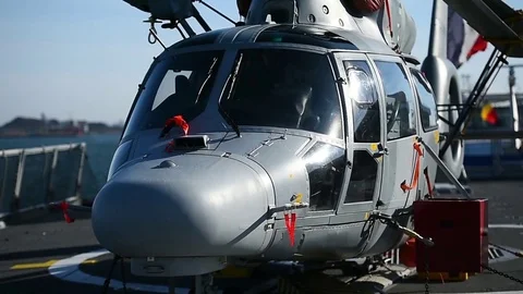 Helicopter parked on a platform of a war frigate Stockbeeldmateriaal 83421110