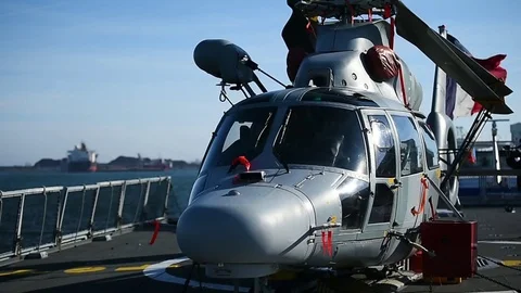 Helicopter parked on a platform of a war frigate Stockbeeldmateriaal 83421229