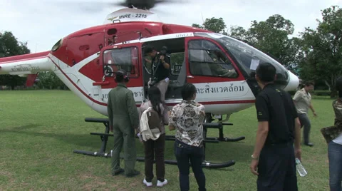HELICOPTER PASSENGERS EMBARK DISEMBARK Stock Footage 29150924