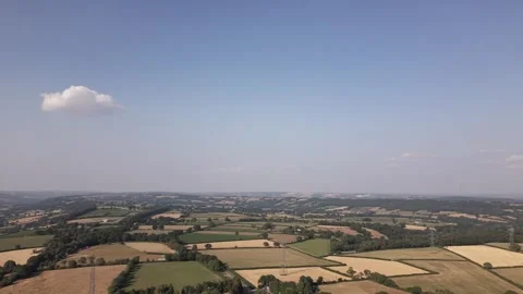 Helicopter Passing a Lone Cloud Above Farmland Stock Footage 347970972