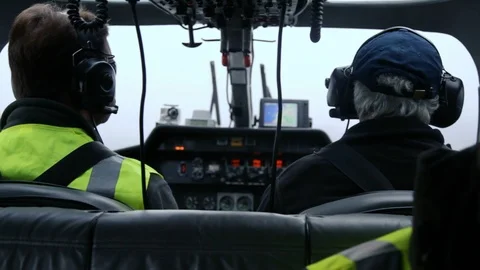 Helicopter pilot and copilot view from behind flying in cloud Stock Footage 118266454