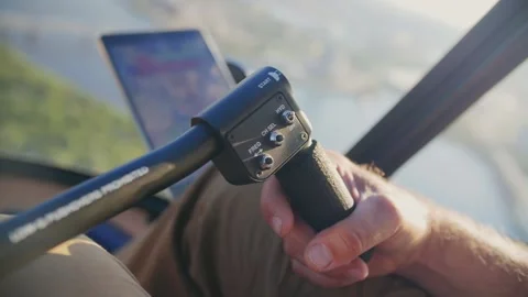 Helicopter pilot controls the helicopter and flies over the sea and cities. Stock Footage 200808367