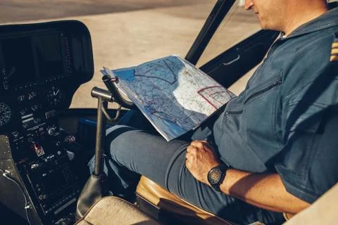 Helicopter pilot reading map. Stock Photos