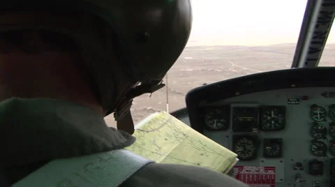 Helicopter pilot reads map while flying Stock-Footage 41056741