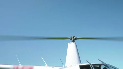 Helicopter powerful engine moving main blades against blue sky background before Stock-Footage 273250575