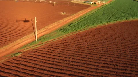 Helicopter shadow moving over green and brown farm land Stock Footage 53049405