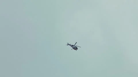 Helicopter shot from below against blue and cloudy overcast sky 動画素材 344271579