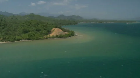 Helicopter shot from coastline panning over to open ocean with with caps waves Stock Footage 549953
