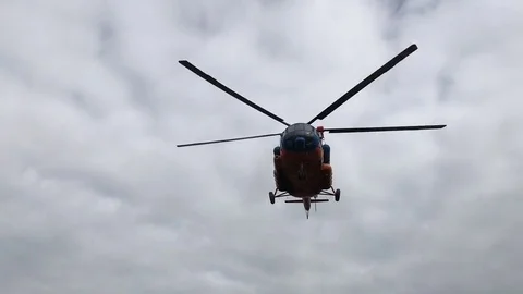 The helicopter in the sky is low above the ground. Stock Footage 80083354