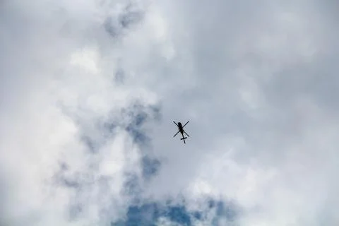 Helicopter in the sky with white clouds Foto stock