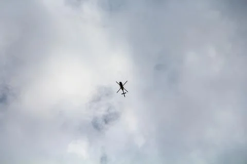 Helicopter in the sky with white clouds Foto stock