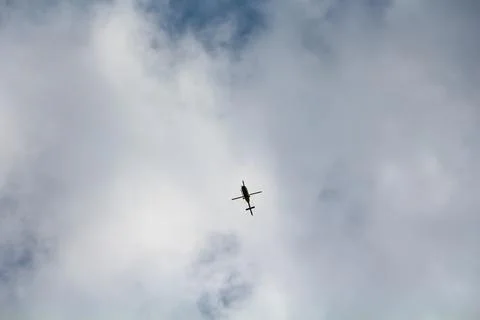 Helicopter in the sky with white clouds Stock Photos