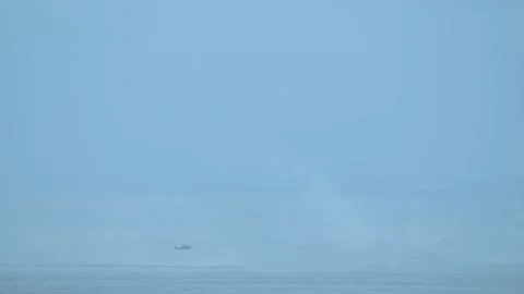 Helicopter soaring over Pacific Ocean coastline near Oregon, aerial view of sea Stock Footage 309322471