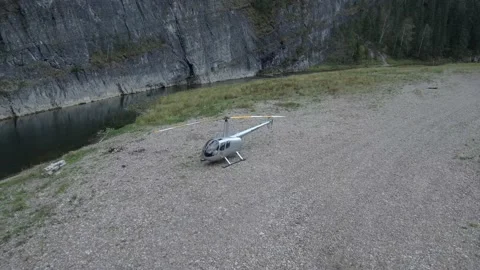 The helicopter is standing on the river, starting to spin the blades. Stock Footage 148427588