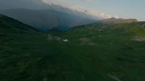 Helicopter at summer sunset greenery mountain valley ridge aerial view Stock Footage 330076505